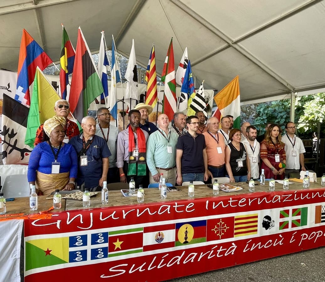 El 9 d’agost de 2022, una delegació de l’AMI a les Ghjurnate Internaziunale que organitza el moviment nacionalista cors, Corsica Libera, a la població de Corti (Còrsega).